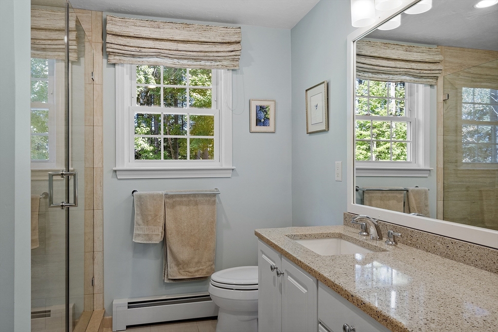 3 Brandy Hollow Littleton, MA 01460 - Photo 20 of 40 a bathroom with a granite countertop toilet a sink and a window