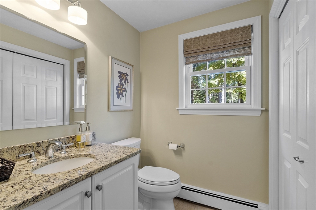 3 Brandy Hollow Littleton, MA 01460 - Photo 26 of 40 a bathroom with a granite countertop toilet a sink and a mirror