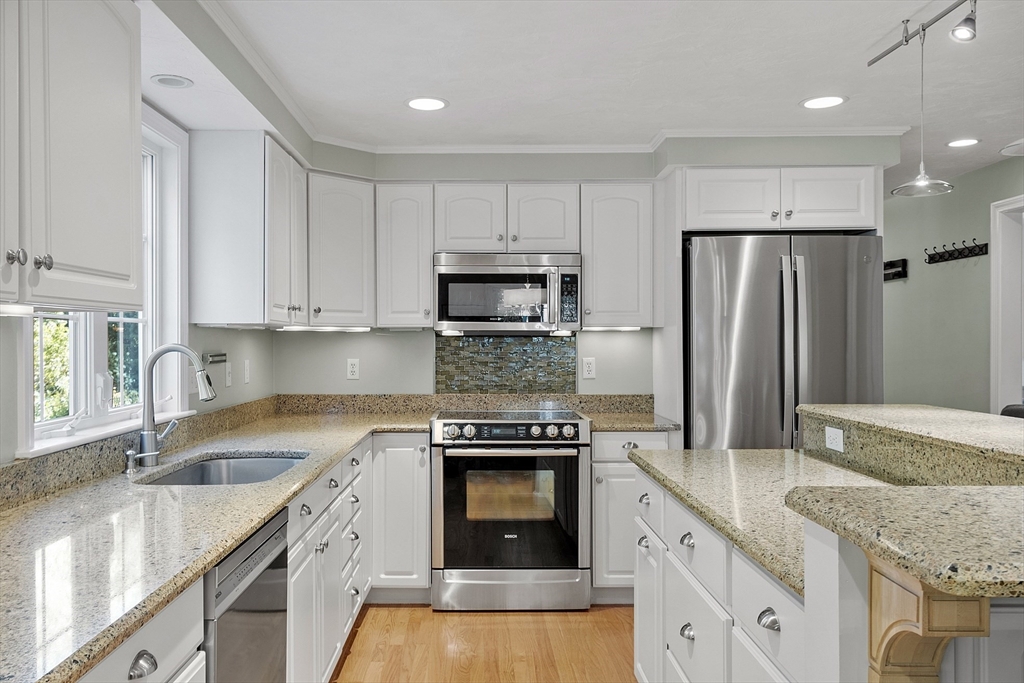 3 Brandy Hollow Littleton, MA 01460 - Photo 5 of 40 a kitchen with granite countertop a stove sink and refrigerator