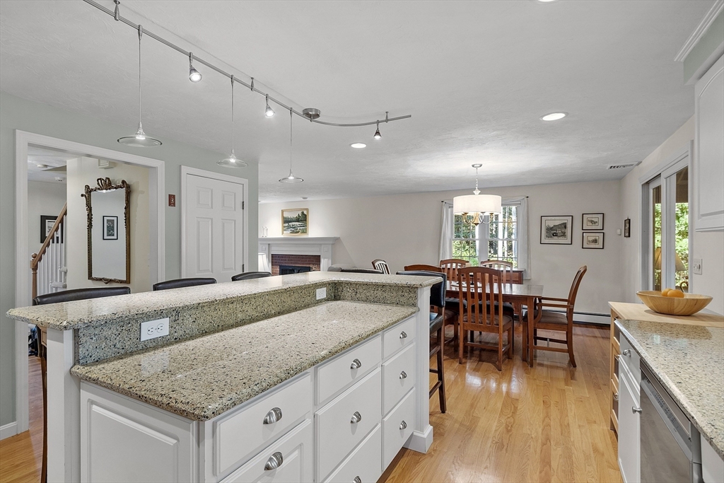 3 Brandy Hollow Littleton, MA 01460 - Photo 6 of 40 a view of living room kitchen island dining table and wooden floor