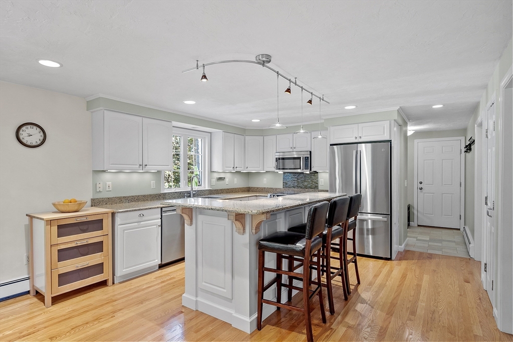 3 Brandy Hollow Littleton, MA 01460 - Photo 8 of 40 a kitchen with a table and chairs in it