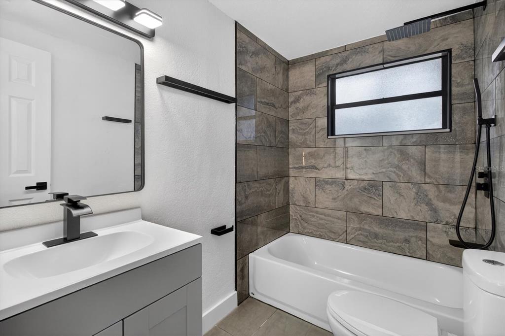 5612 Mallow Street New Port Richey, FL 34652 - Photo 18 of 43 a bathroom with a sink a toilet and shower