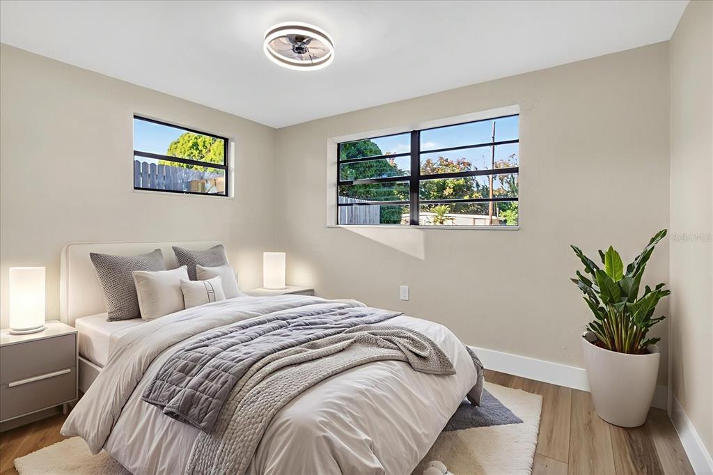 5612 Mallow Street New Port Richey, FL 34652 - Photo 26 of 43 a bedroom with a bed and a potted plant