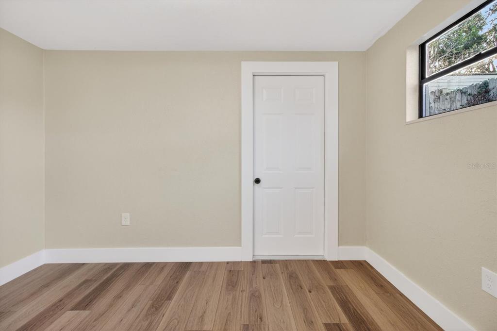 5612 Mallow Street New Port Richey, FL 34652 - Photo 29 of 43 a view of an empty room with wooden floor and a window