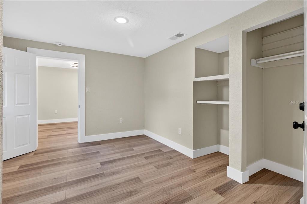5612 Mallow Street New Port Richey, FL 34652 - Photo 33 of 43 wooden floor in an empty room with a window