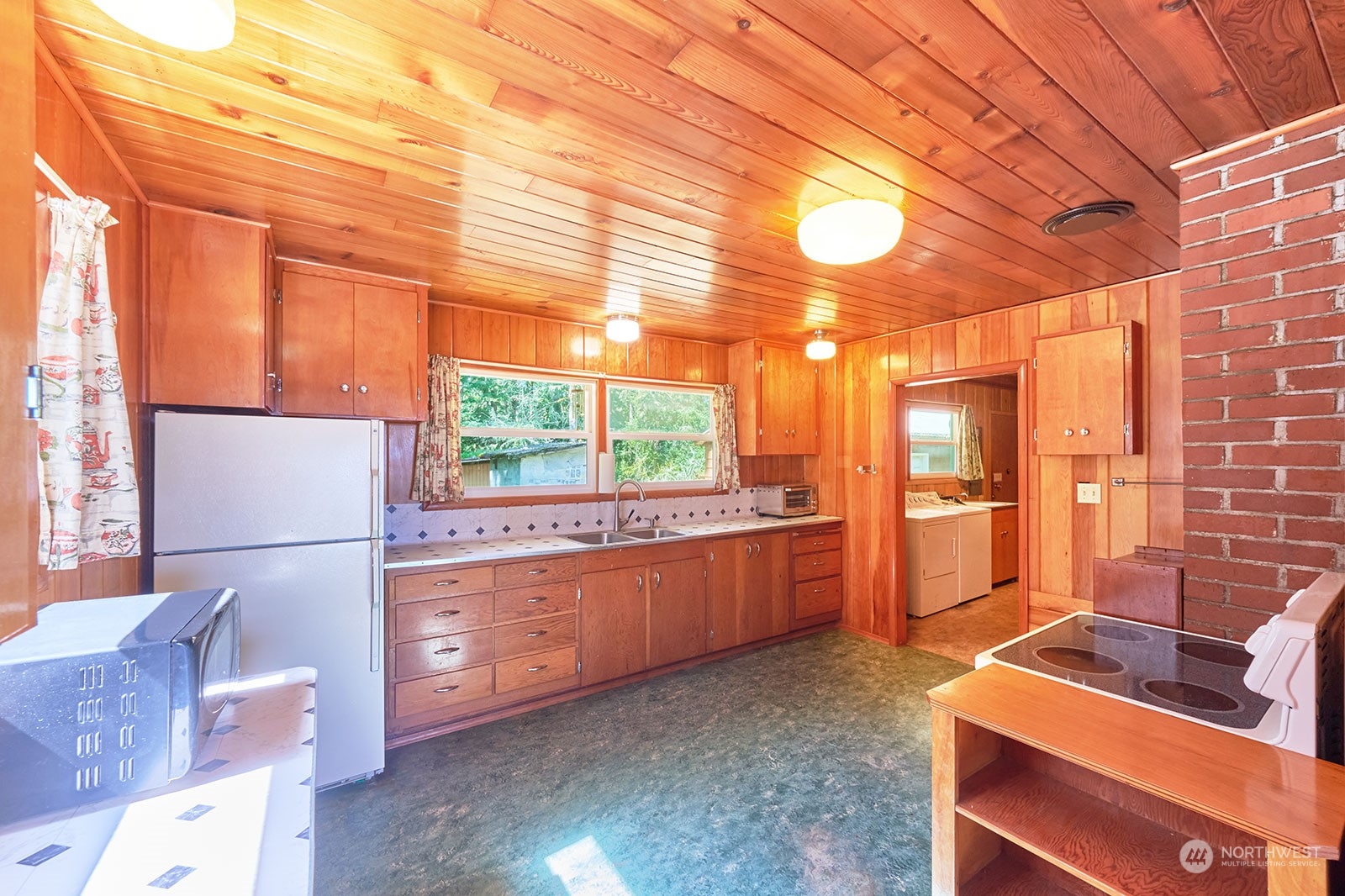 30708 Sandridge Road Ocean Park, WA 98640 - Photo 11 of 37 a kitchen with stainless steel appliances kitchen island granite countertop a refrigerator a stove and a sink with dishwasher