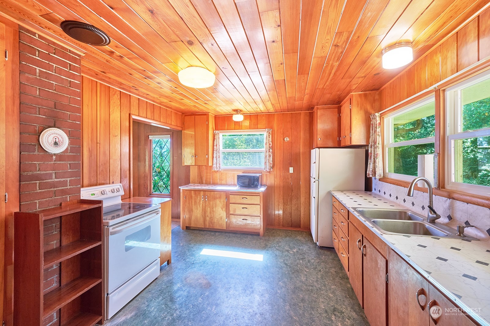 30708 Sandridge Road Ocean Park, WA 98640 - Photo 12 of 37 a kitchen that has a lot of cabinets in it