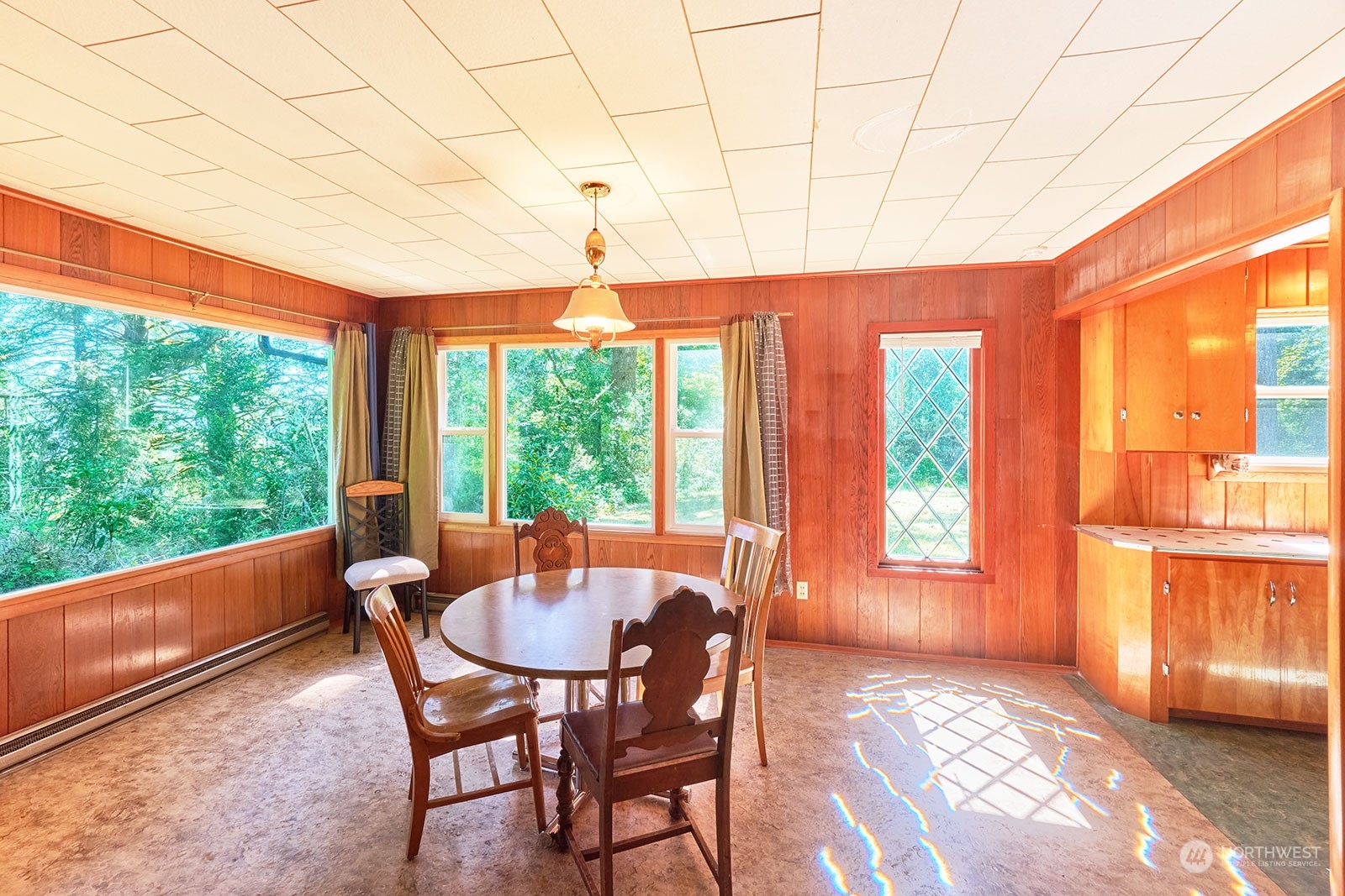 30708 Sandridge Road Ocean Park, WA 98640 - Photo 13 of 37 a view of a dining room with furniture large windows and wooden floor