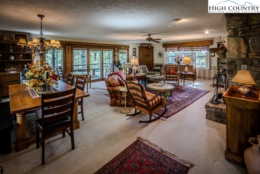 94 Rhododendron Loop Newland, NC 28657 - Photo 11 of 50 a living room with lots of furniture and a chandelier