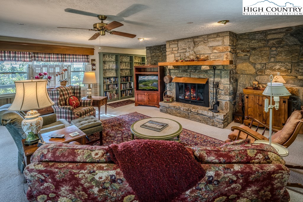 94 Rhododendron Loop Newland, NC 28657 - Photo 13 of 50 a living room with furniture a fireplace and a flat screen tv