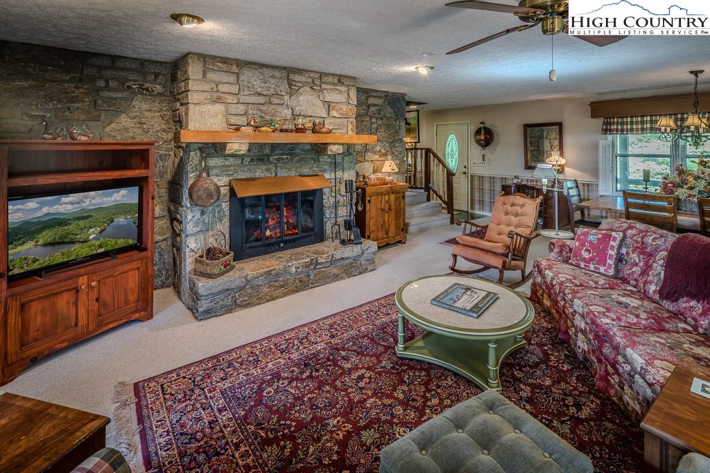 94 Rhododendron Loop Newland, NC 28657 - Photo 15 of 50 a living room with furniture a flat screen tv and a fireplace