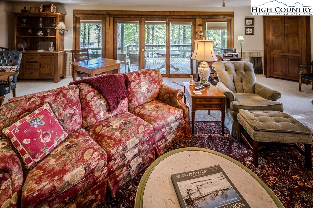 94 Rhododendron Loop Newland, NC 28657 - Photo 17 of 50 a living room with fireplace furniture and a floor to ceiling window