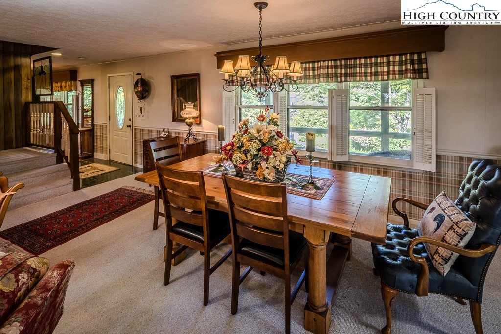 94 Rhododendron Loop Newland, NC 28657 - Photo 20 of 50 a view of a dining room with furniture window and outside view