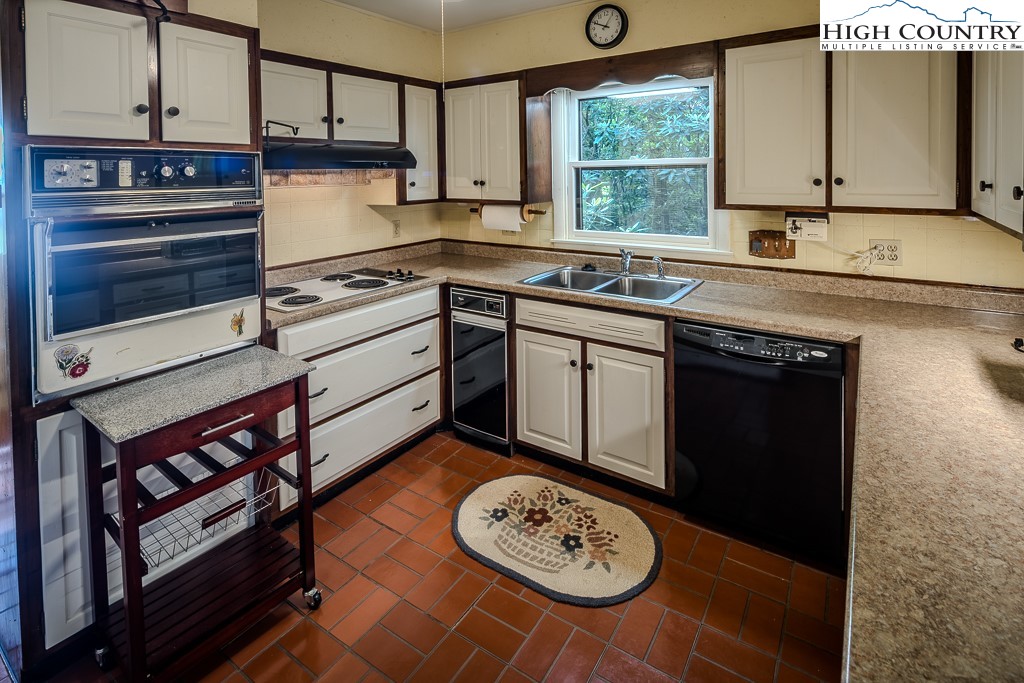 94 Rhododendron Loop Newland, NC 28657 - Photo 24 of 50 a kitchen with a sink cabinets and window
