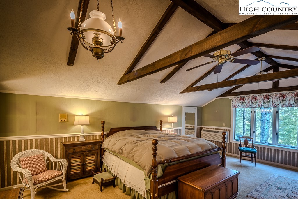 94 Rhododendron Loop Newland, NC 28657 - Photo 29 of 50 a bedroom with a bed and wooden floor