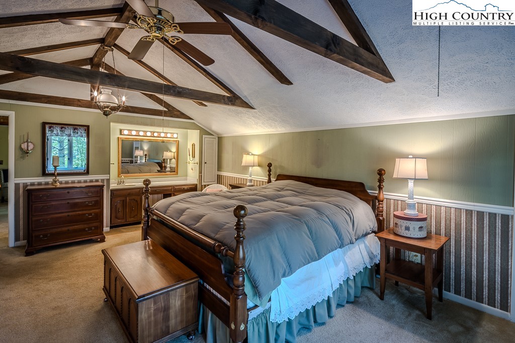 94 Rhododendron Loop Newland, NC 28657 - Photo 30 of 50 a spacious bedroom with a bed and a view of closet