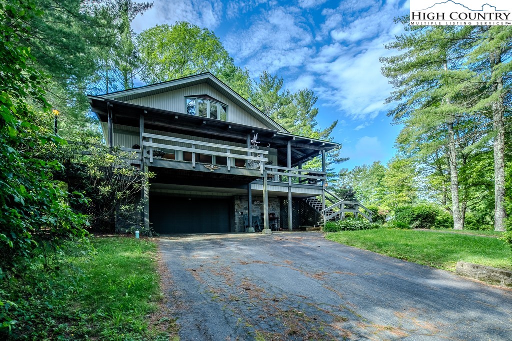94 Rhododendron Loop Newland, NC 28657 - Photo 3 of 50 a front view of a house with a yard and garage