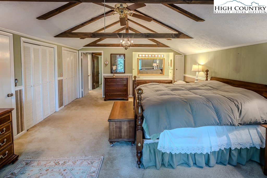 94 Rhododendron Loop Newland, NC 28657 - Photo 31 of 50 a bedroom with a bed and a chandelier