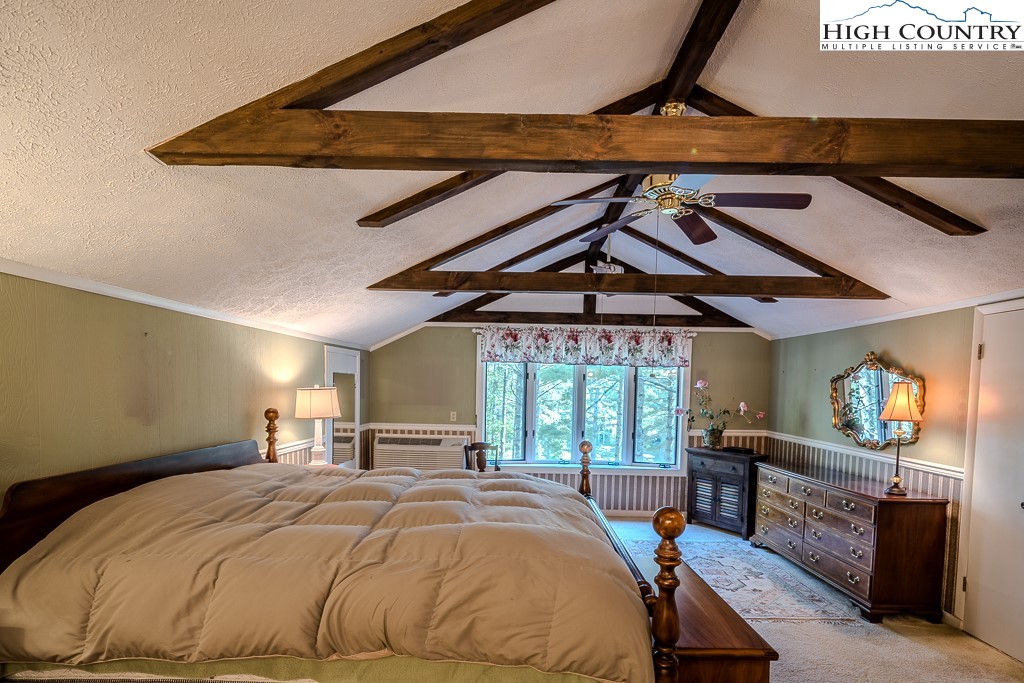 94 Rhododendron Loop Newland, NC 28657 - Photo 34 of 50 a bed sitting in a bedroom next to a window