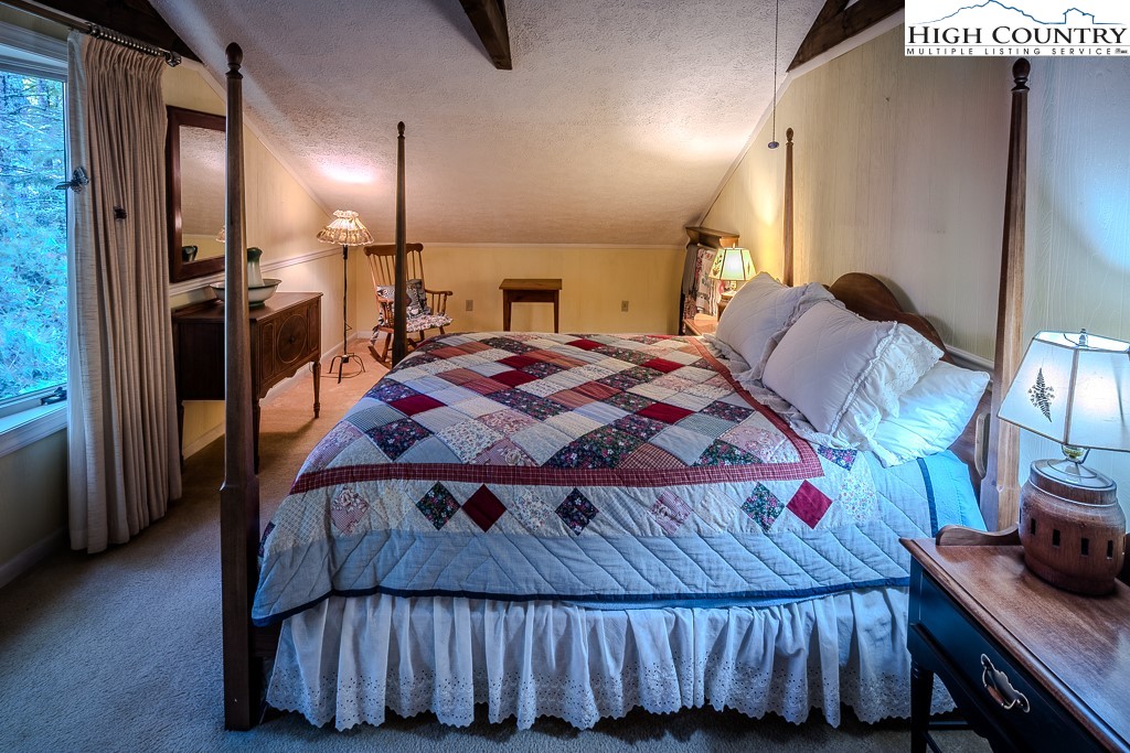 94 Rhododendron Loop Newland, NC 28657 - Photo 37 of 50 a bedroom with a bed and wooden floor