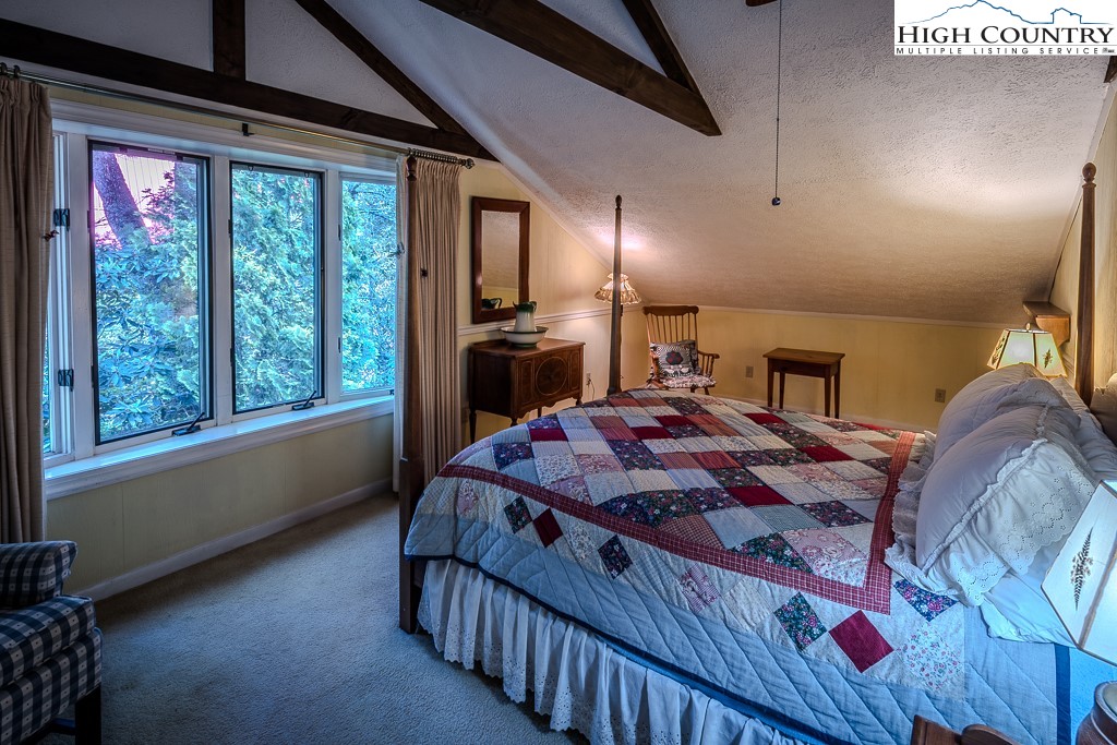94 Rhododendron Loop Newland, NC 28657 - Photo 38 of 50 a bed sitting in a bedroom next to a window