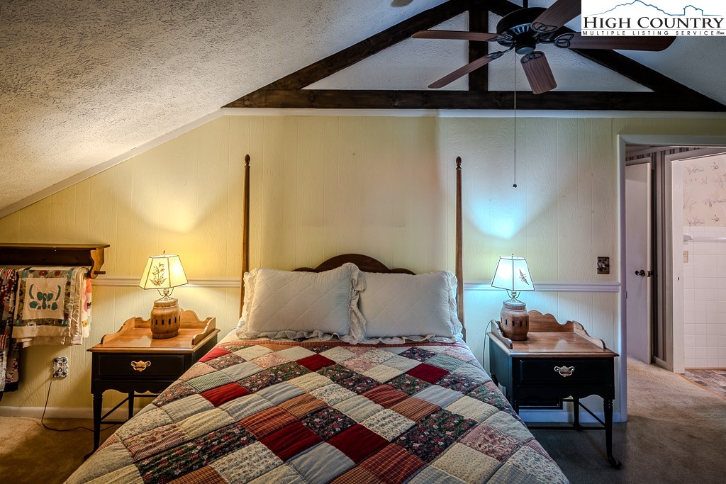 94 Rhododendron Loop Newland, NC 28657 - Photo 39 of 50 a bedroom with a bed and wooden floor