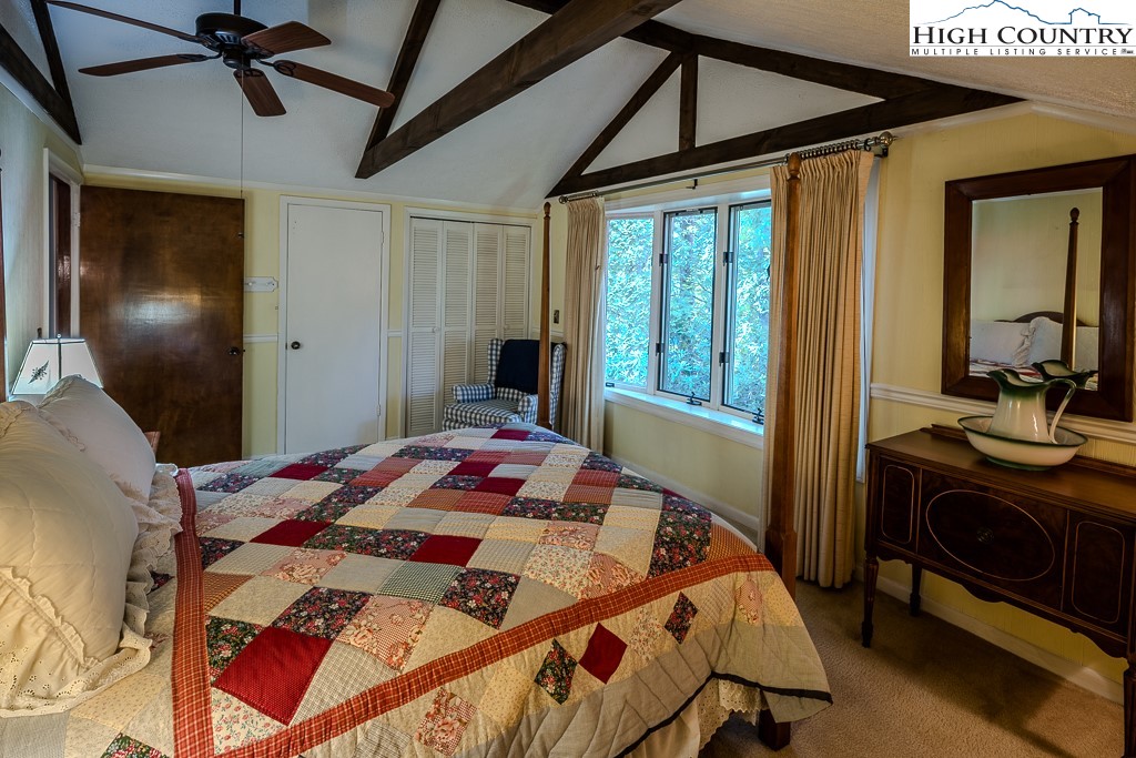 94 Rhododendron Loop Newland, NC 28657 - Photo 40 of 50 a bedroom with a bed and a chandelier