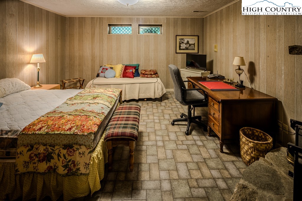 94 Rhododendron Loop Newland, NC 28657 - Photo 41 of 50 a bedroom with a bed and a table in it