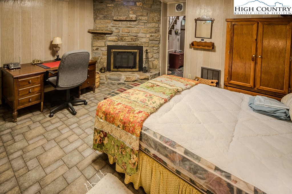 94 Rhododendron Loop Newland, NC 28657 - Photo 43 of 50 a bedroom with a bed chair and fireplace