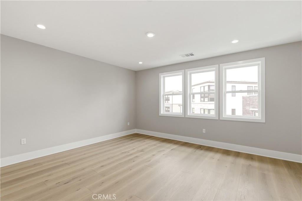 156 Apron Irvine, CA 92618 - Photo 32 of 40 an empty room with wooden floor and windows