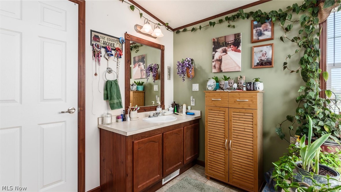 66092 Pisgah Road Quaker City, OH 43773 - Photo 17 of 28 Bathroom with tile flooring and vanity with extensive cabinet space