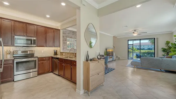 a kitchen with stainless steel appliances granite countertop a refrigerator stove and sink