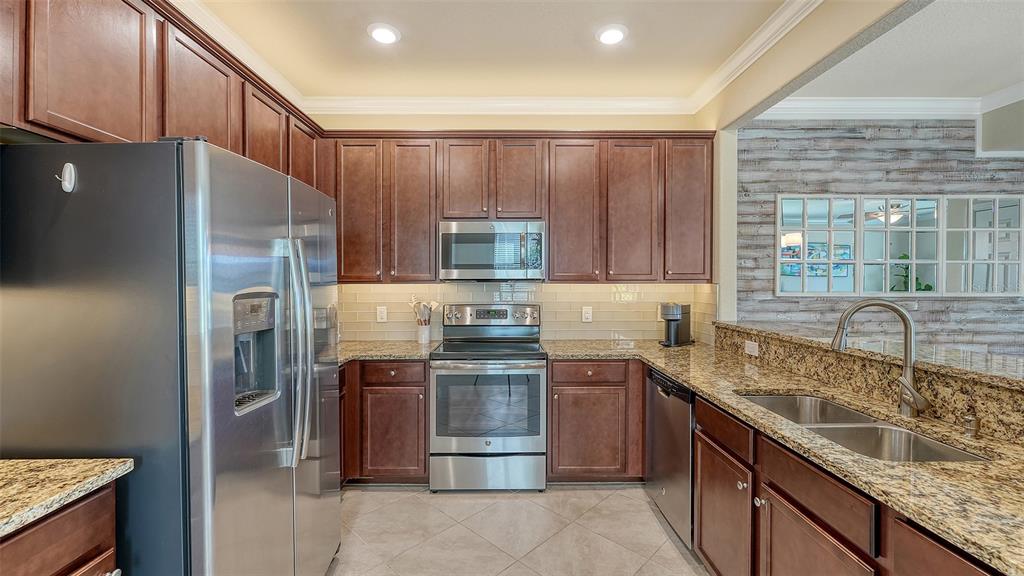 20223 Lagente Circle Venice, FL 34293 - Photo 13 of 71 a kitchen with stainless steel appliances granite countertop a refrigerator stove and sink