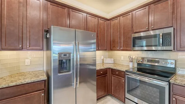 a kitchen with sink refrigerator and window