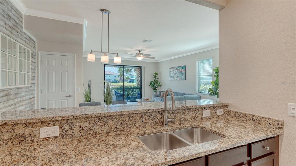 20223 Lagente Circle Venice, FL 34293 - Photo 15 of 71 a kitchen with sink refrigerator and window