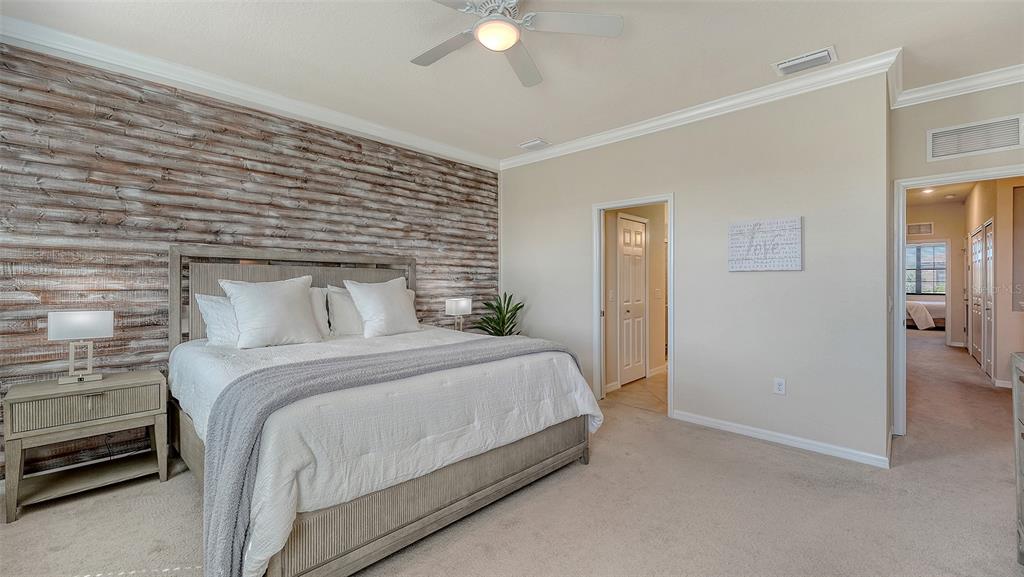 20223 Lagente Circle Venice, FL 34293 - Photo 20 of 71 a bedroom with a bed and a chandelier