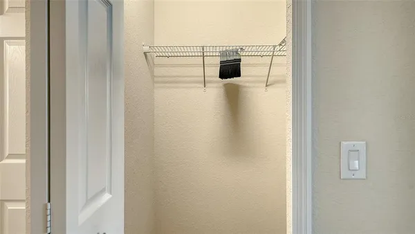 a view of room with window and a ceiling fan