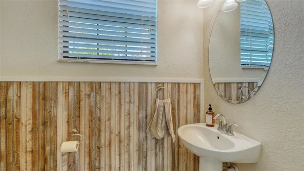 a living room with furniture a chandelier and a fireplace