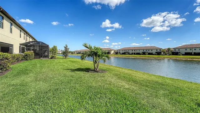 a view of a house with swimming pool and sitting area