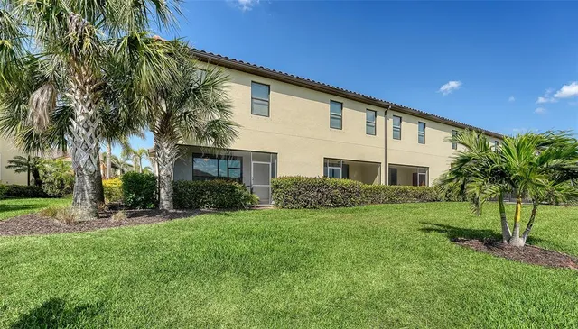 a view of a house with swimming pool and sitting area