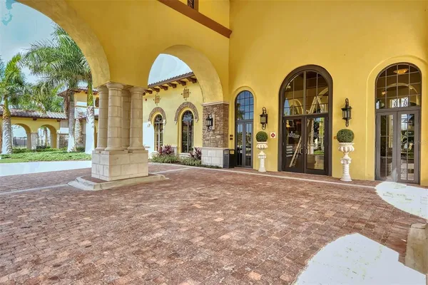 an empty room with windows and ceiling fan