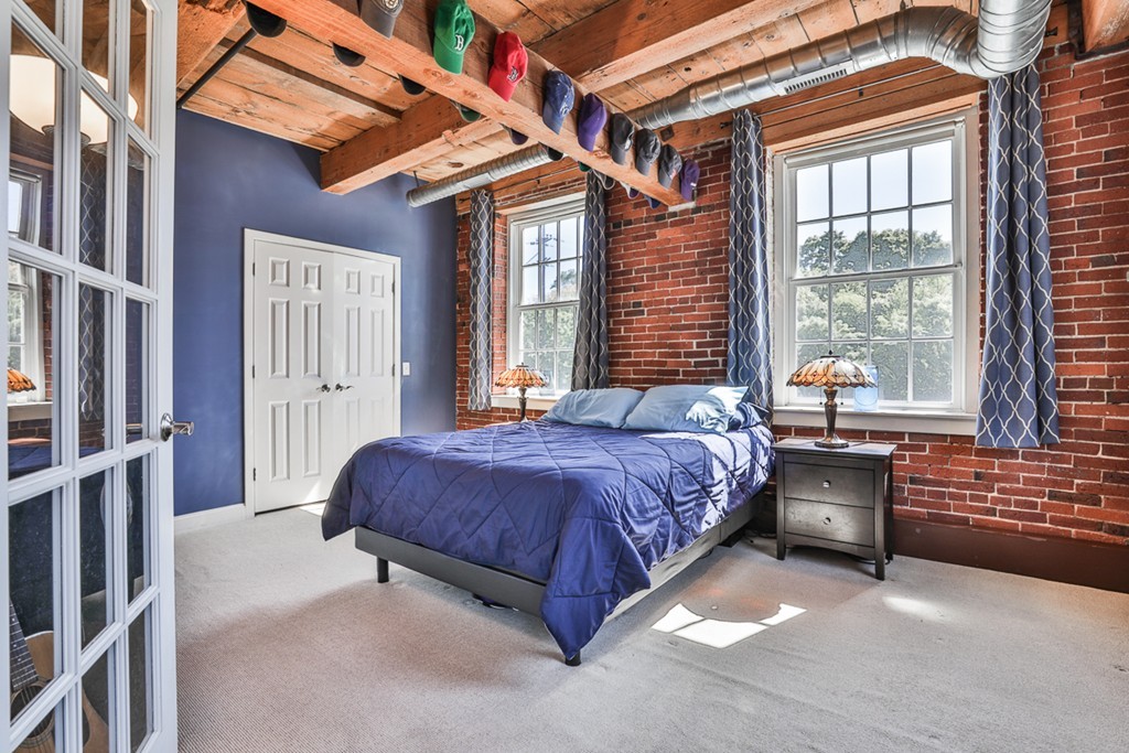 25 Cedar Street, Unit 4 Amesbury, MA 01913 - Photo 11 of 20 a spacious bedroom with a bed and a window