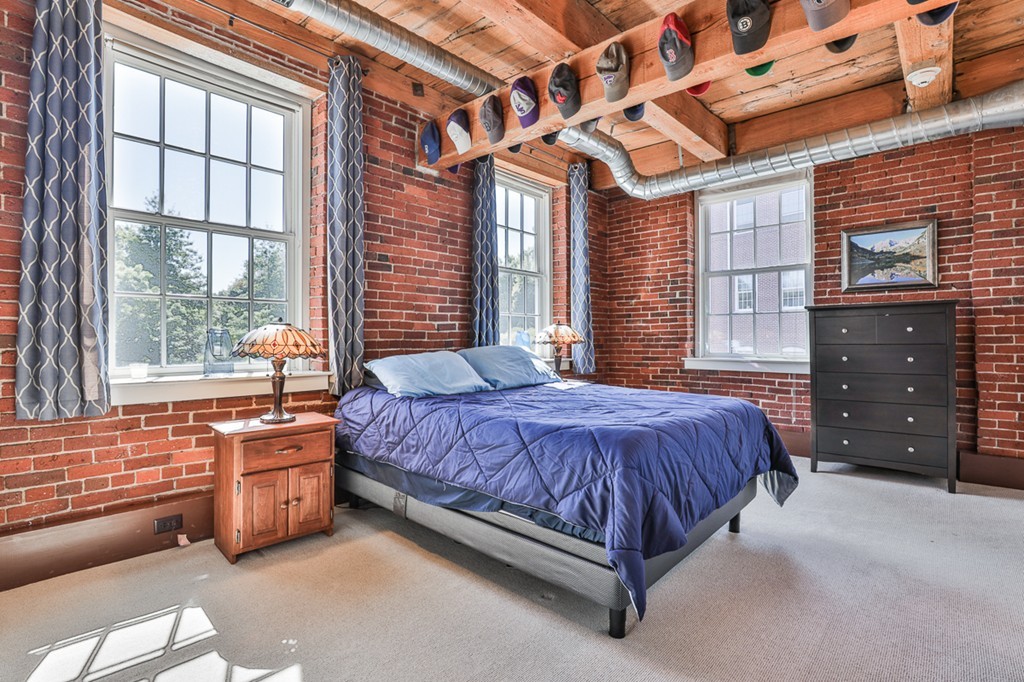 25 Cedar Street, Unit 4 Amesbury, MA 01913 - Photo 13 of 20 a spacious bedroom with a bed and a dresser next to a window