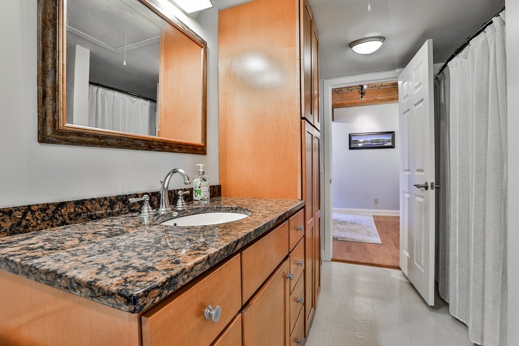 25 Cedar Street, Unit 4 Amesbury, MA 01913 - Photo 14 of 20 a bathroom with a granite countertop sink and a mirror