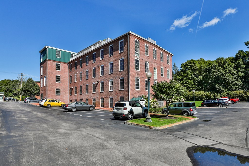25 Cedar Street, Unit 4 Amesbury, MA 01913 - Photo 17 of 20 a view of building with cars parked in front of it