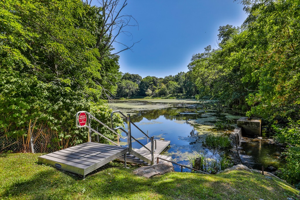 25 Cedar Street, Unit 4 Amesbury, MA 01913 - Photo 20 of 20 a view of a bench in a garden near a lake