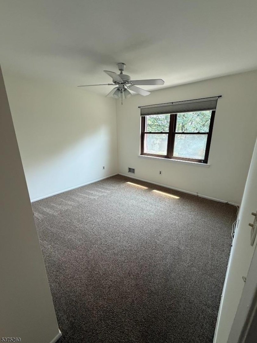 606 Nottingham Way Flemington, NJ 08822 - Photo 12 of 17 an empty room with chandelier fan and windows