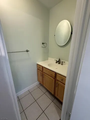 a spacious bathroom with a mirror and a sink