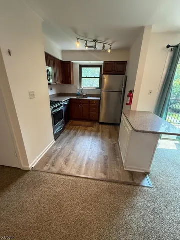 a kitchen with stainless steel appliances a refrigerator and a stove top oven