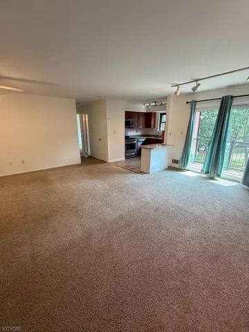 a view of a big room with furniture and a kitchen